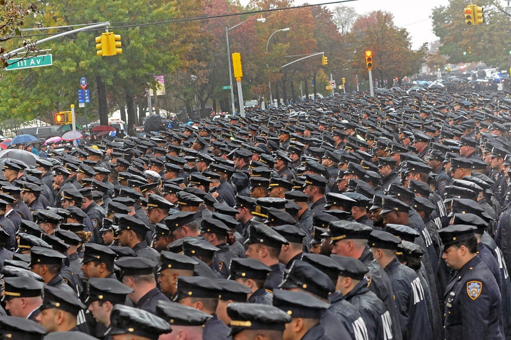 Crowds mourn slain NYPD officer as suspect indicted for murder