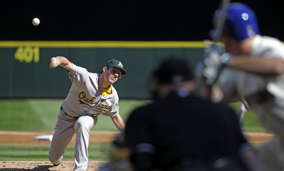 Oakland Athletics starting pitcher Chris Bassitt throws against the Seattle Mariners Seth Smith in the second inning of a baseball game Sunday Oct. 4 2015 in Seattle