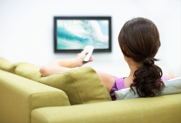 Young woman watching television