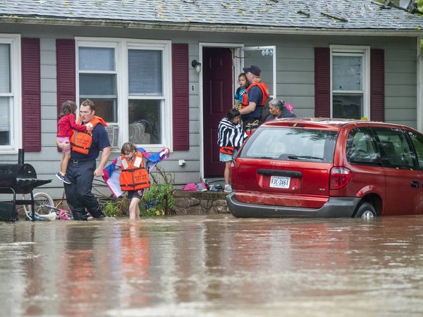 Emergency responders help a family evacuate their home as floodwaters block the road in Harrisonburg Va. on Tuesday Sept. 29 2015