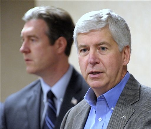 Mich. Gov. Rick Snyder announces support in the city of Flint's plan to switch back to Detroit water due to high lead levels during a news conference in Flint Mich. on Thursday Oct. 8 2015. Flint stopped using water from the Detroit system last year