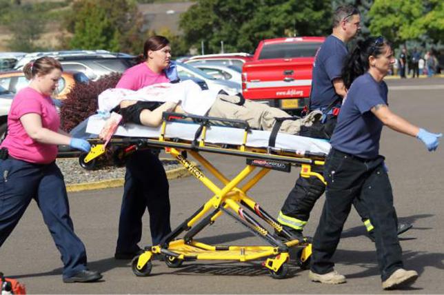 First responders transport an injured person following a shooting incident at Umpqua Community College in Roseburg Oreg