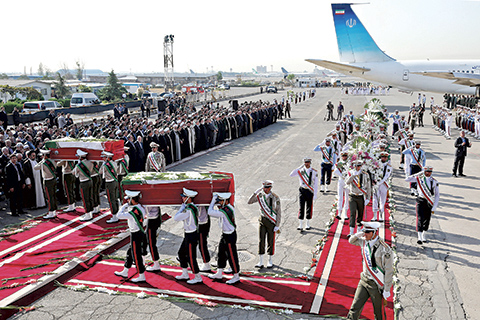 An Honor guard carries the coffins of Iranian hajj pilgrims who were killed in a deadly stampede in Mina near Mecca in Saudi Arabia on September 24 at Mehrabad airport in Tehran Iran Saturday Oct. 3 2015. The first plane carrying bodies of Iranian