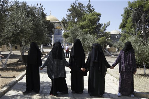 Palestinian female activists form a chain to prevent a group of religious Jews from coming close to the Dome of the Rock at the Al Aqsa compound in Jerusalem. Jewish and Muslim activists self-declared defenders of