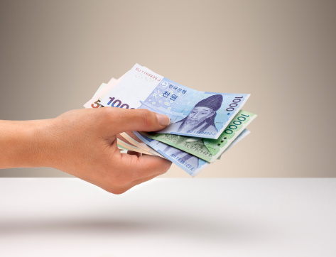 Hand holding Korean currency | By Anthony Bradshaw | Getty Images