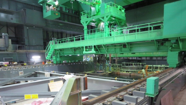 Workers move a cask at Fukushimi Daiichi Nuclear Power Plant