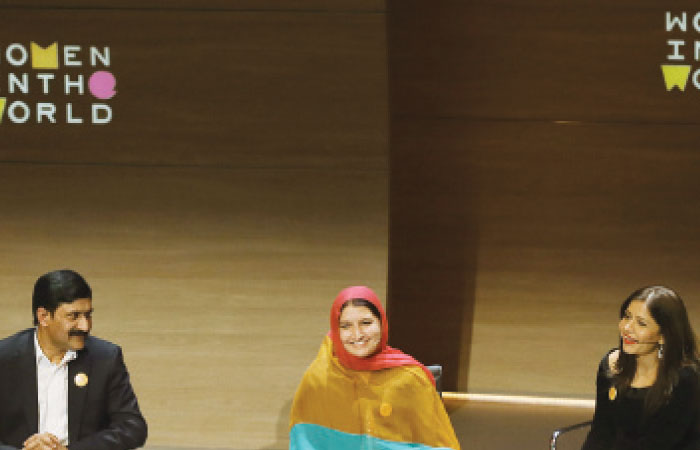 The mother and father of Malala Yousafzai Ziauddin Yousafzai left and Toor Pekai Yousafzai second left speak with a translator second right and filmmaker Samar Minallah Khan right during the Women in the World Summit at Cadogan Hall in London