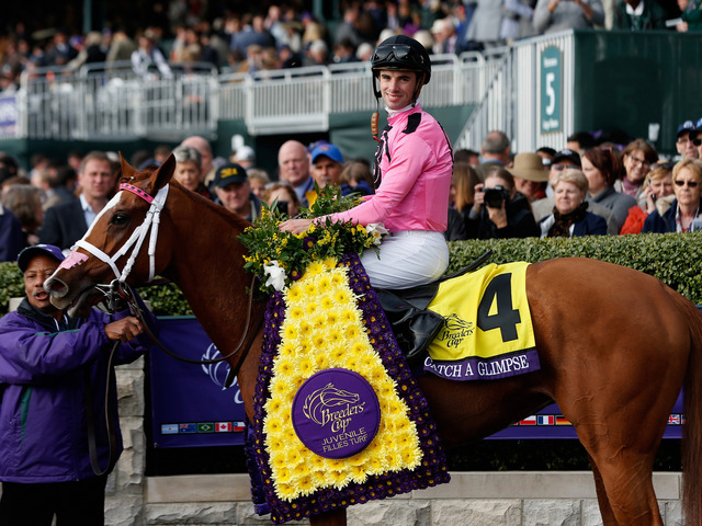 Florent Geroux smiles in the winners circle aboard Catch A Glimpse after winning the Breeders Cup Juvenile Fillies Turf