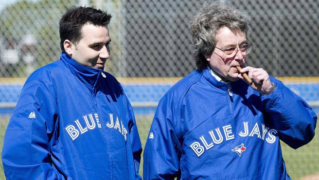 Toronto Blue Jays President and CEO Paul Beeston right and general manager Alex Anthopoulos talk as they watch the Blue Jays during baseball spring training in Dunedin Fla. in February 2013