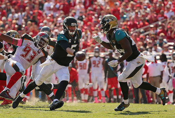 Blake Bortles #5 hands off to T.J. Yeldon #24 of the Jacksonville Jaguars