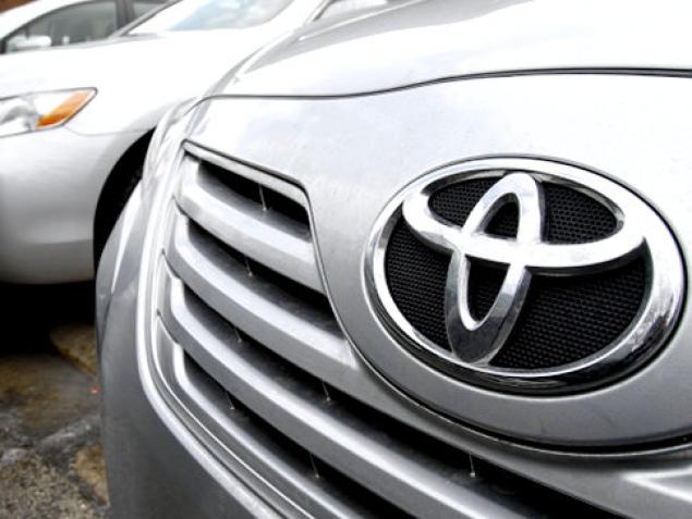 Toyota cars are lined up for service at a Toyota dealership