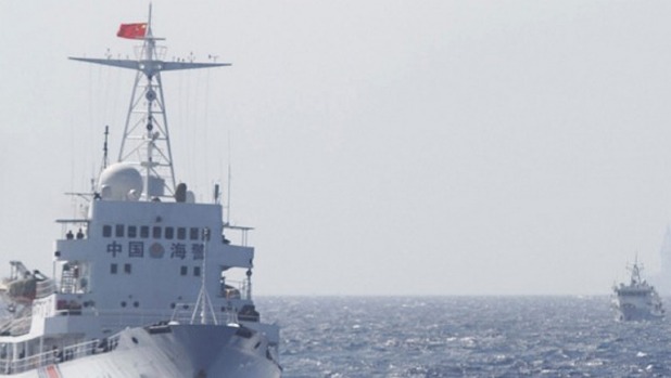 Ships of Chinese Coast Guard are seen near the Chinese oil rig Haiyang Shi You 981 in disputed waters in the South China Sea about 210 km from Vietnam last year