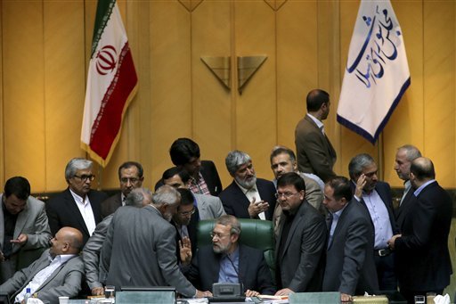 Oct. 11 2015 Iran's parliament speaker Ali Larijani center speaks with lawmakers in an open session of parliament while discussing a bill on Iran's nuclear deal with world powers in Tehran Iran. Iran's parliament voted