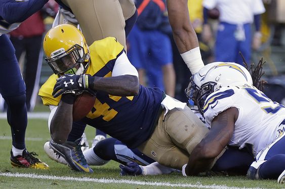 Green Bay Packers James Starks goes in for a five-yard touchdown reception as he is tackled by San Diego Chargers Denzel Perryman during the first half of an NFL football game in Green Bay Wis. With