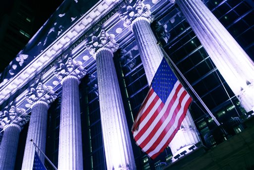 American flag flies in front of the New York Stock Exchange. Global stock markets rose Wednesday Oct. 7 2015 taking in stride the IMF's lower global growth forecast as oil prices extended a rebound. (AP