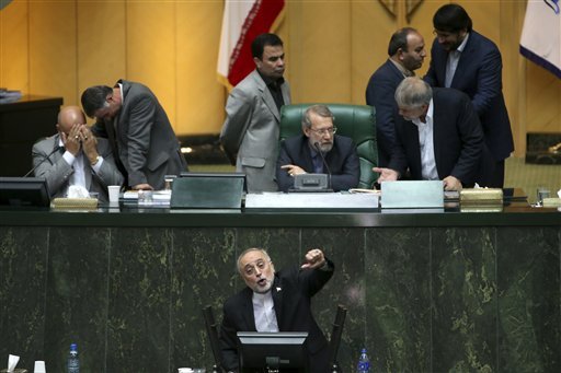 Head of Iran's Atomic Energy Organization Ali Akbar Salehi bottom speaks in an open session of parliament while discussing a bill on Iran's nuclear deal with world powers in Tehran Iran Sunday Oct. 11 2015. Iran's official IRNA news agency reported