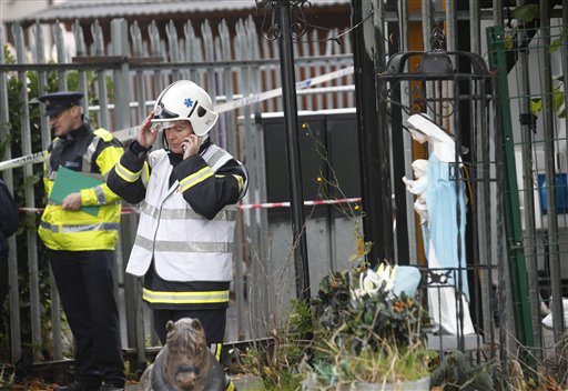 Emergency services attend the scene of a fire in Carrickmines Dublin Ireland Saturday Oct. 10 2015. Police say nine people including an infant have died in a fire at a mobile home camp for Irelands native Gypsies. Detectives say they have yet