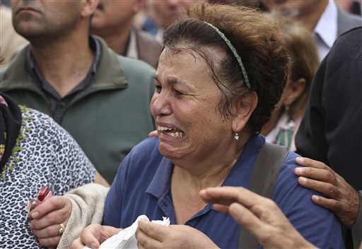 A protester is overcome with emotion during a rally to protest Saturday's explosions in Ankara Turkey Sunday Oct. 11 2015. Turkey declared three days of mourning following Saturday's nearly simultaneous explosions that targeted a peace rally