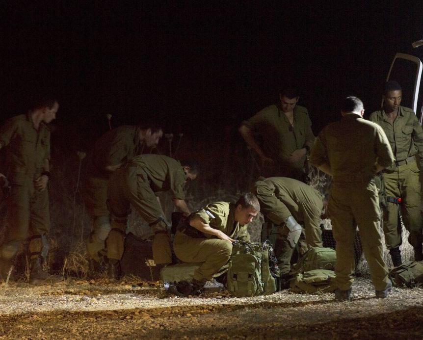 Israeli soldiers searching for the paraglider in Golan Heights on Saturday EPA