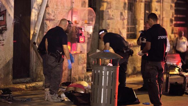 Israeli forces inspect the body of a Palestinian man after shooting him dead near al Quds central bus station