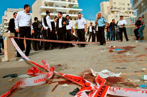 Israeli ultra-orthodox Jews gather at the site where two alleged Palestinian attackers were shot by Israeli police after attempting to board a bus carrying children Credit Gil Cohen Magen