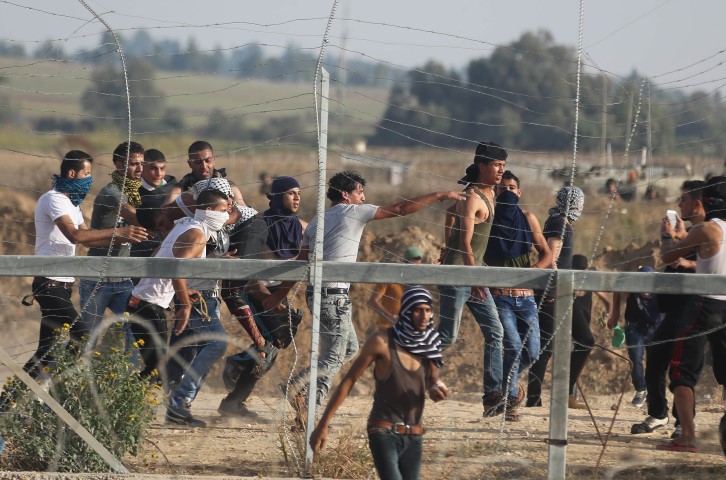 A wounded Palestinian protester is carried away after he was shot by Israeli troops near the border between Israel and Central Gaza Strip. REUTERS  Ibraheem Abu Mustafa