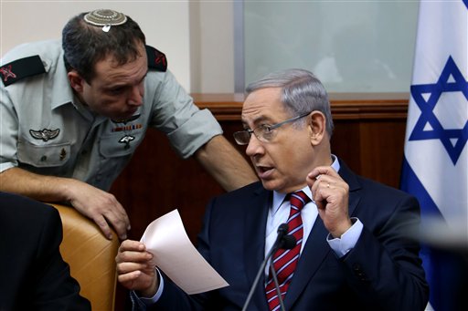 Israel's Prime Minister Benjamin Netanyahu speaks his military secretary Brigadier General Eliezer Toledano left during the weekly cabinet meeting at his office in Jerusalem Sunday Oct. 25 2015