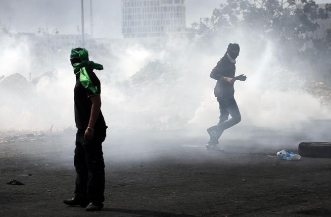 Palestinian stone throwers clash with Israeli security forces in Beit El on the outskirts of the West Bank city of Ramallah