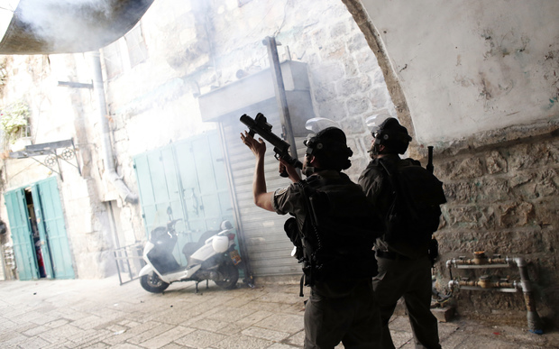 15 shows Israeli police using stun grenades to disperse Palestinian demonstraters in al Wad street in the Muslim quarter of Jerusalem's Old City