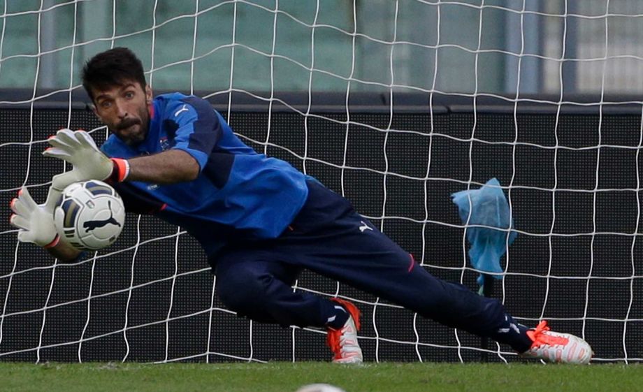 Italy’s goalkeeper Gianluigi Buffon reaches for the ball during a training session at Rome's Olympic Stadium Monday Oct. 12 2015. Italy will play Norway in a Euro 2016 soccer qualifying group H match Tuesday Oct. 13