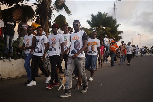 Supporters of Ivory Coast incumbent President Alassane Ouattara walk during an election rally in Abidjan Ivory Coast Friday Oct. 23 2015. Ivory Coasts president is widely expected to win a second term as the West African nation votes Sunday five