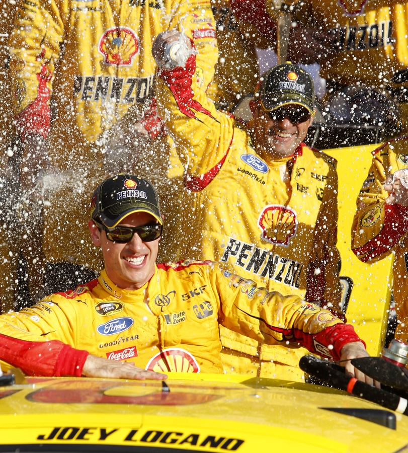 Joey Logano celebrates in Victory Lane after winning Sunday's NASCAR race at Kansas Speedway in Kansas City Kan