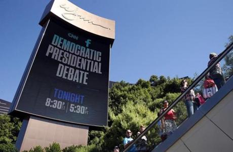 People walked under a billboard promoting the CNN Democratic presidential debate in Las Vegas