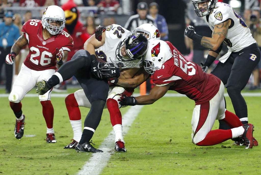 Baltimore Ravens tight end Nick Boyle scores a two point conversion as Arizona Cardinals middle linebacker Kevin Minter defends during the second half of an NFL football game Monday Oct. 26 2015 in Glendale Arizona