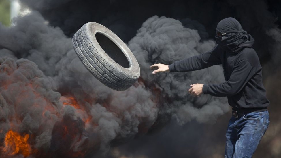 Palestinians burn tires during clashes with Israeli troops near Ramallah West Bank Friday