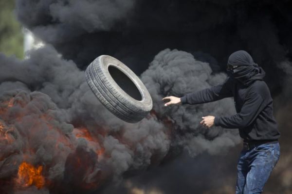 Palestinians burn tires during clashes with Israeli troops