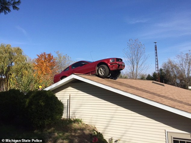 Kaboom A Ford Mustang is stopped on Joyce Kingsley's roof in Woodhull Township Michigan