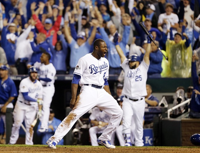 Kansas City Royals Lorenzo Cain celebrates after scoring on a hit by Eric Hosmer against the Toronto Blue Jays during the eight inning in Game 6 of baseball's American League Championship Series on Friday Oct. 23 2015 in Kansas City Mo. (AP