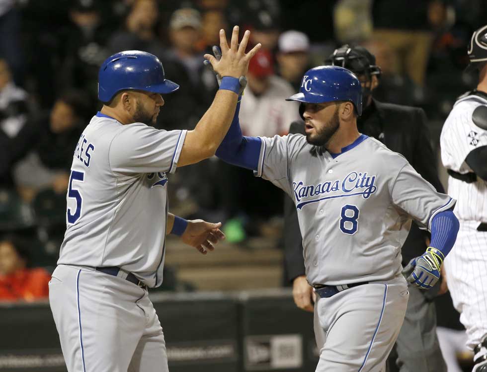 Kendrys Morales and Mike Moustakas celebrate Moustakas 2-run home run against the White Sox