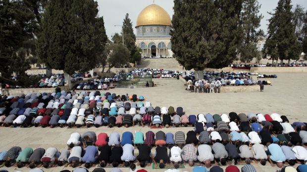 Worshippers pray outside the Dome of the Rock in Jerusalem on Friday after Israel lifted age restrictions on Muslims seeking to access the area which is holy to both Muslims and Jews