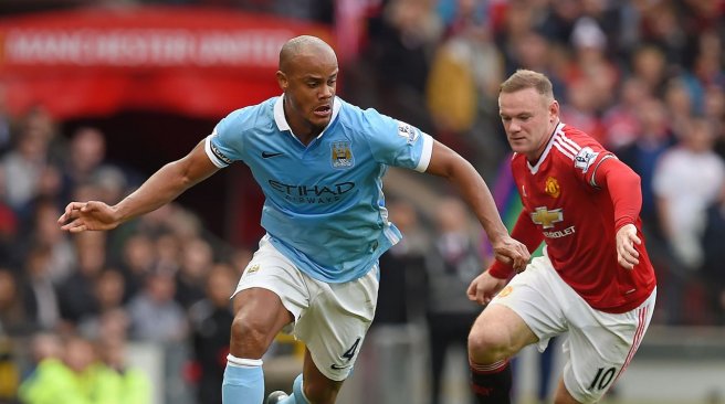 Manchester United striker Wayne Rooney challenges Manchester City defender Vincent Kompany during the English Premier League football match between Manchester United and Manchester City at Old Trafford in Manchester. AFP