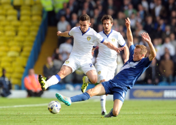 Leeds United's Lewis Cook is tackled by City's Maikel Kietenbeld