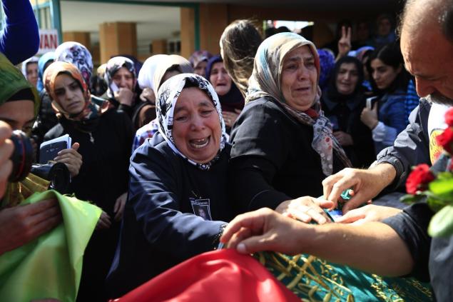 Relatives of one of the victims killed in Saturday's bombing attacks in Ankara cries during the funeral in Istanbul on Monday