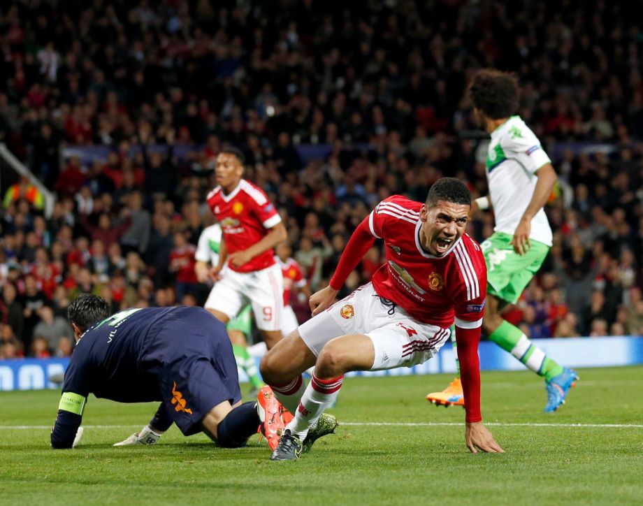 Manchester United’s Spanish midfielder Juan Mata runs to get the ball after scoring from the penalty spot during the UEFA Champions League Group B football match between Manchester United and VfL Wolfsburg in Manchester England