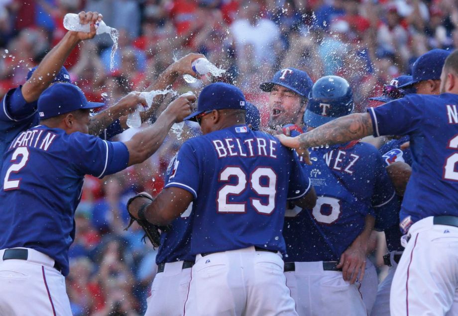 Texas Rangers starting pitcher Cole Hamels back is mobbed by his teammates after the final out of the baseball game against the Los Angeles Angels in Arlington Texas Sunday Oct. 4 2015. The Rangers clinched the AL West title on the last day of the