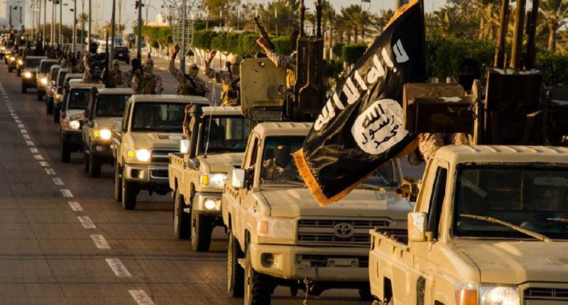 An image made available by propaganda Islamist media outlet Welayat Tarablos in February 2015 allegedly shows members of the Islamic State militant group parading in a street in Libya's coastal city of Sirte