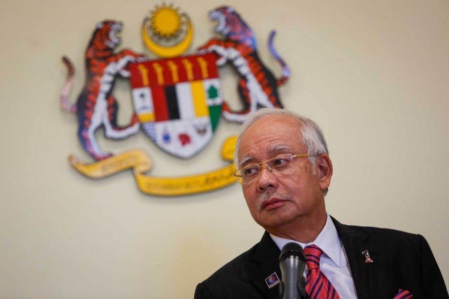 Malaysian Prime Minister Najib Razak pauses while speaking at a press conference in Putrajaya Malaysia. Malaysia's attorney general on Thursday Oct. 8 2015 defended the government over a debt scandal as the