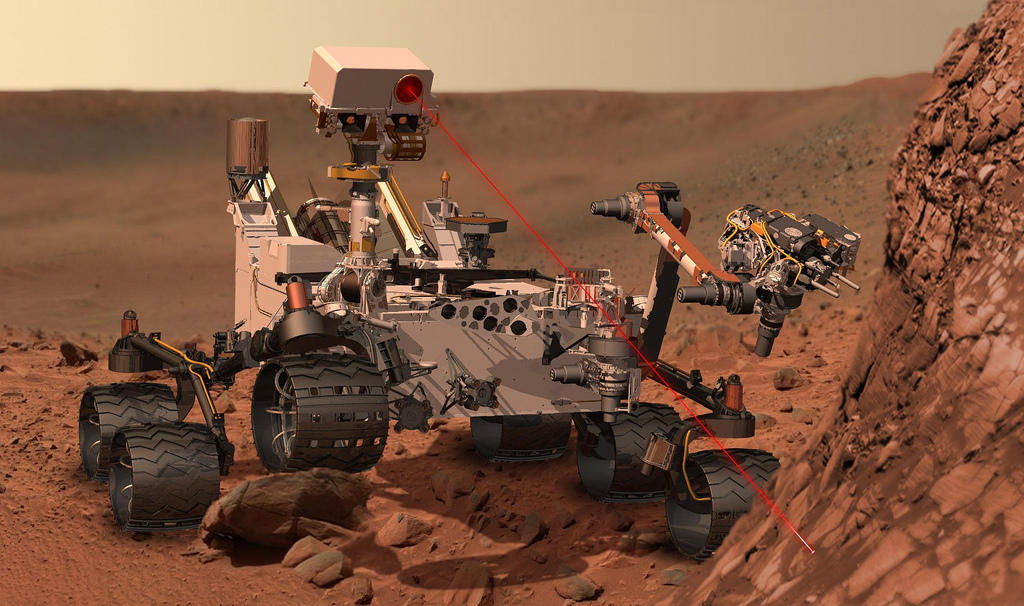 This artist's concept depicts the rover Curiosity of NASA's Mars Science Laboratory mission as it uses its'Chemistry and Camera instrument to investigate the composition of a rock surface