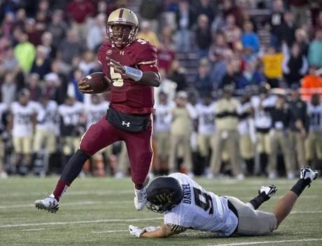 Chestnut Hill MA 10/10/15 Boston College Eagles quarterback Jeff Smith breaks the tackle from Wake Forest Demon Deacons Zach Dancel during fourth quarter action at Alumni Stadium on Saturday