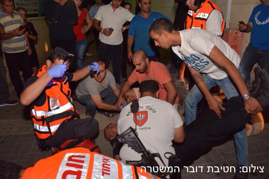 Medics working on a soldier who was stabbed in Afula